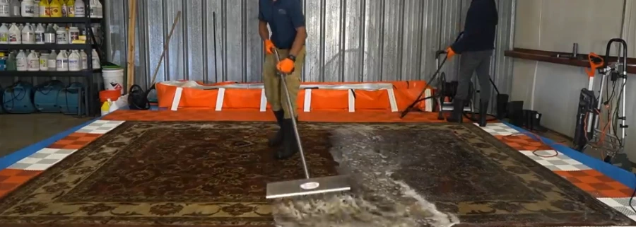 Technician performing truck-mounted hot water extraction carpet cleaning in Medford, Oregon